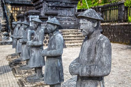 Stone mandarin statues at a royal tomb in Hue