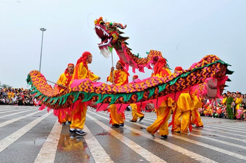 Vietnamese dragon dance performance during festival with long dragon costume and coordinated group movement