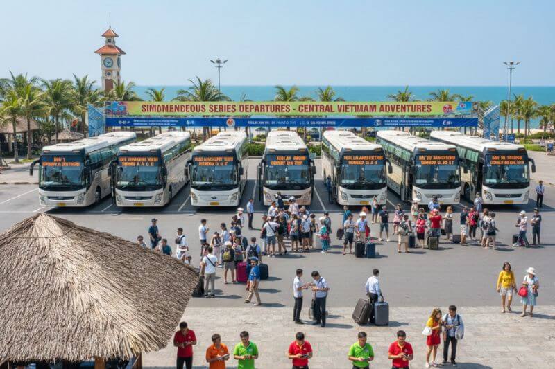 Multi-coach departure coordination with numbered bays and group leader check-in for three simultaneous series departures at a central Vietnam beach resort