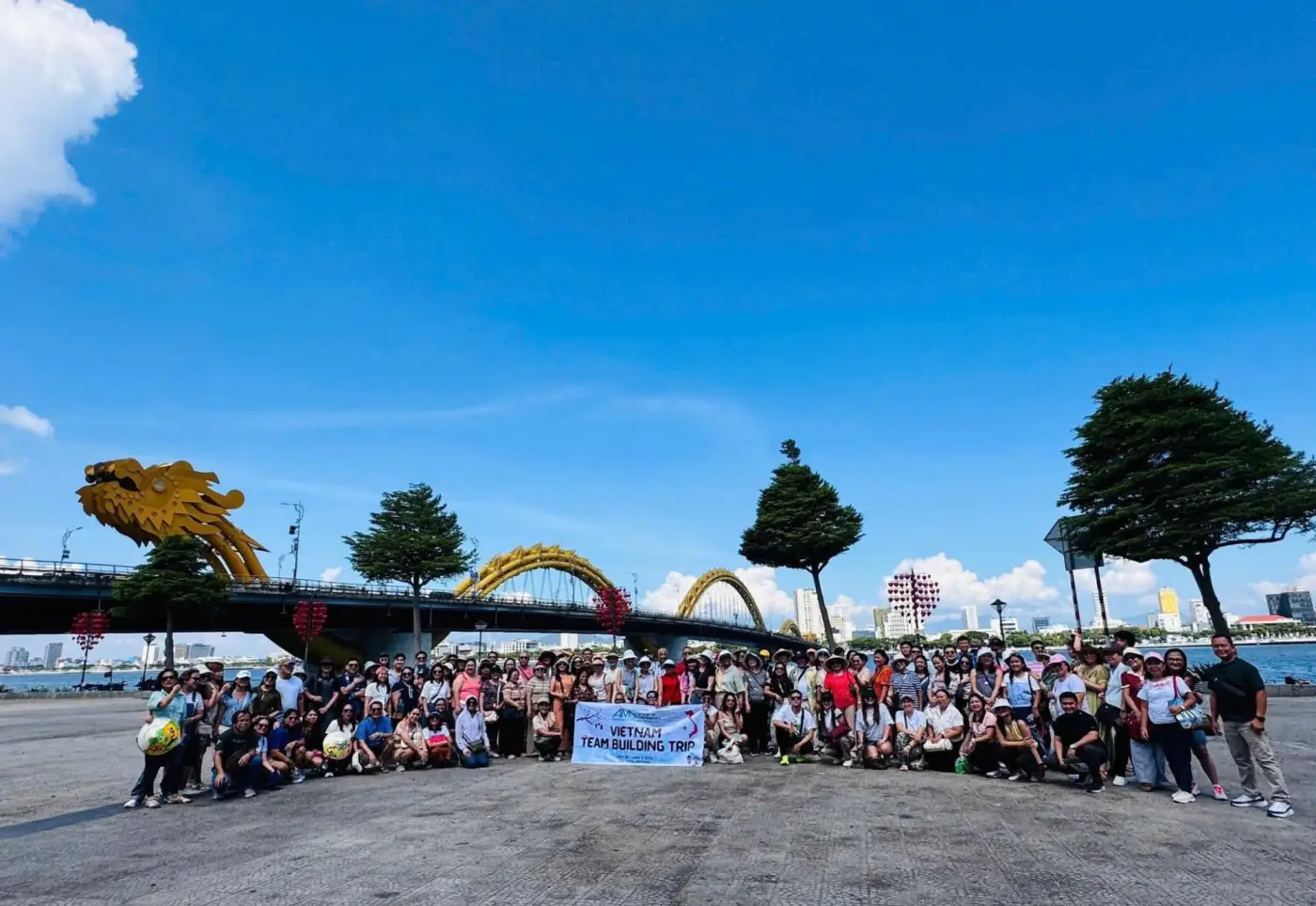 Hospital team-building group at the Dragon Bridge in Da Nang, June 2026